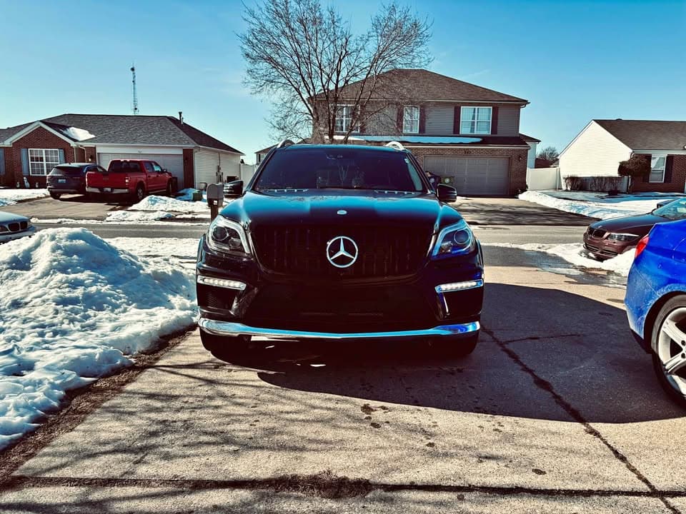 Front view of a black Mercedes-Benz SUV parked in a driveway